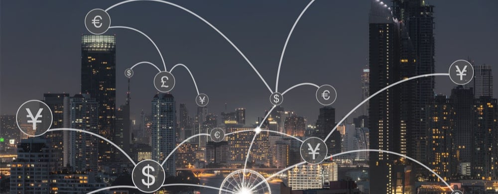 Illuminated cityscape with overlaid currency symbols and connecting lines representing global.