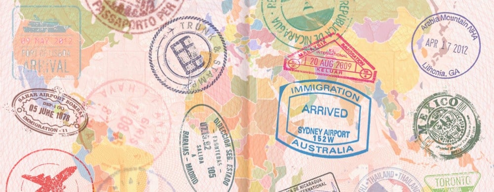 A collection of colorful passport stamps and immigration marks from various countries and airports.
